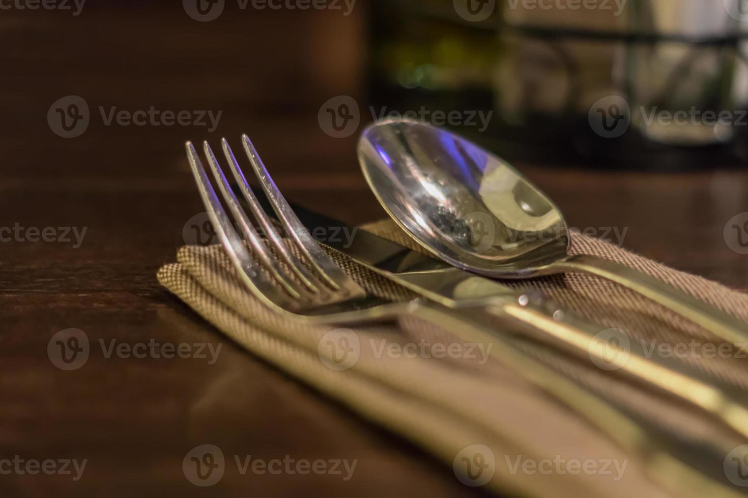 Served fork, spoon and knife on table. photo