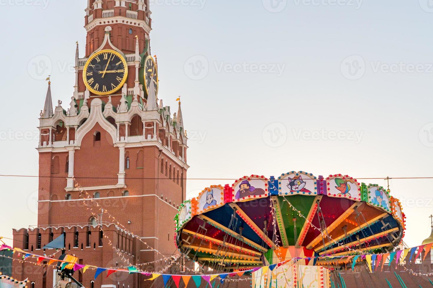 Spasskaya tower of Kremlin and Merry-go-round carousel on Red Square in Moscow photo