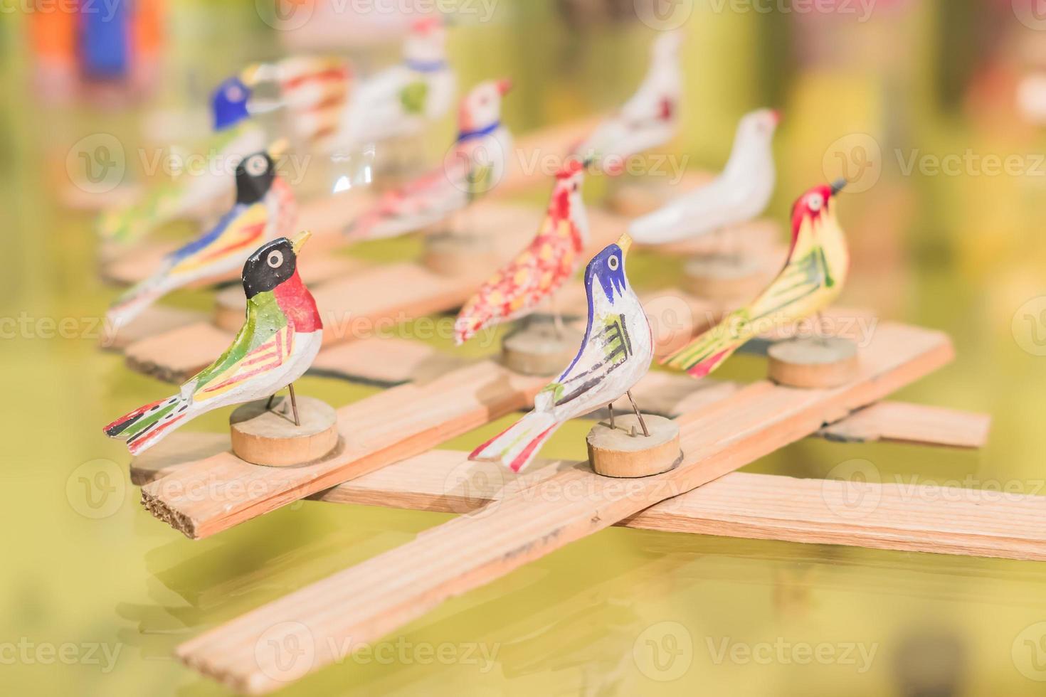 wooden toy in shape of birds on glass shelf photo