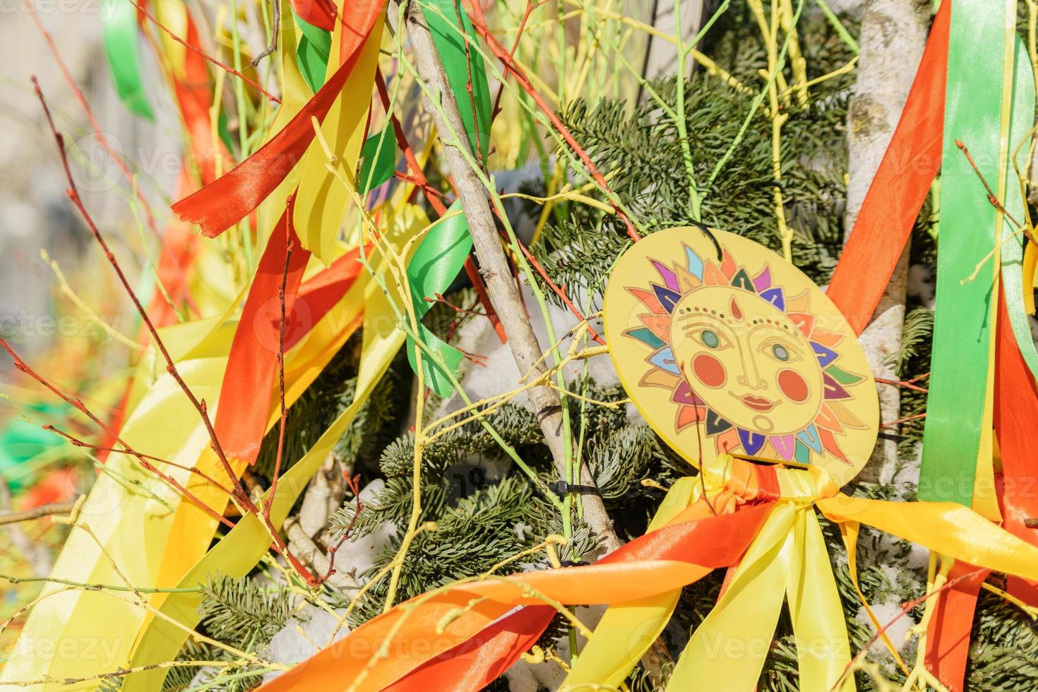 Decorated fir trees with symbols of Shrovetide and ribbons photo