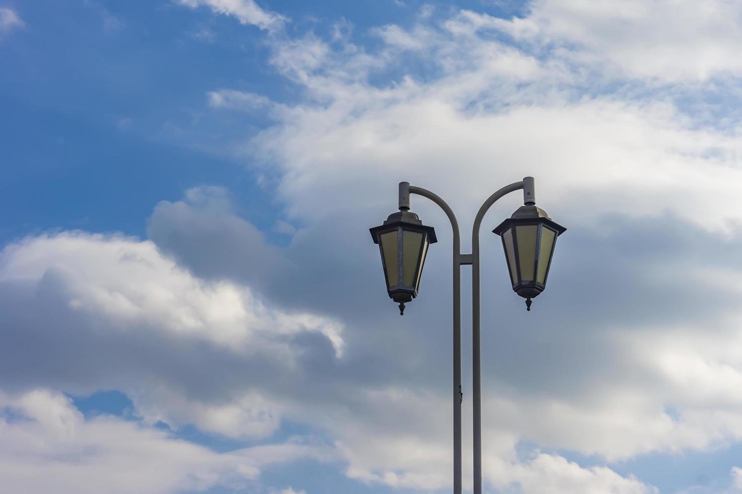Street light against blue sky photo