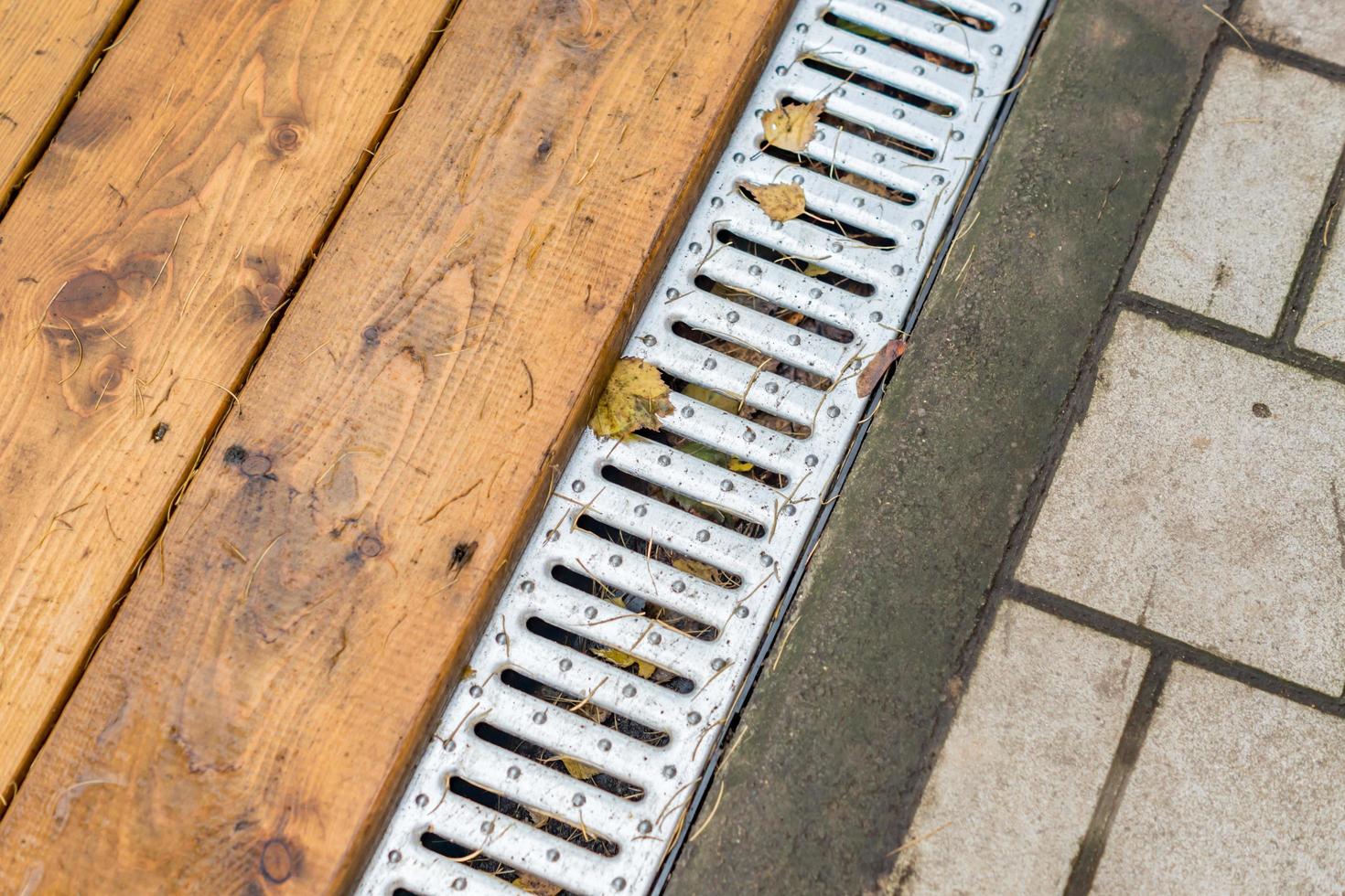 street drain in autumn park photo