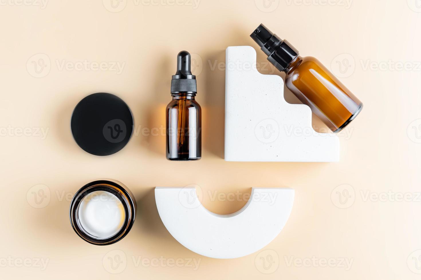Cosmetics mockup. Set of skin care products for aging skin with collagen and peptides. Dark glass bottles for branding. knolling layout photo