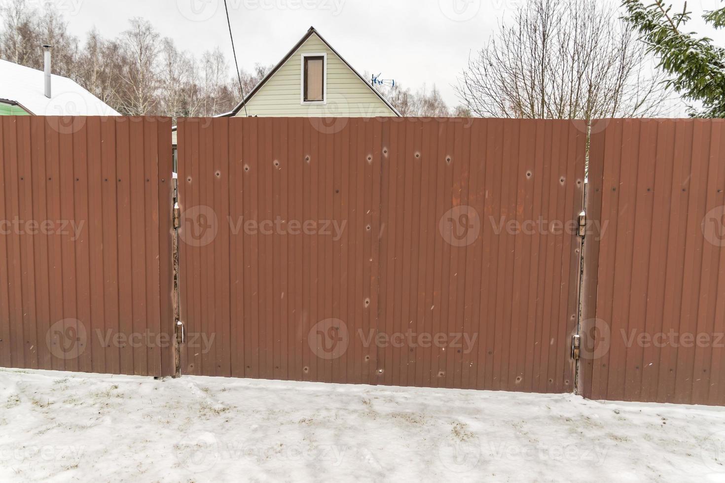 closeup of brown metal fence in countryside photo