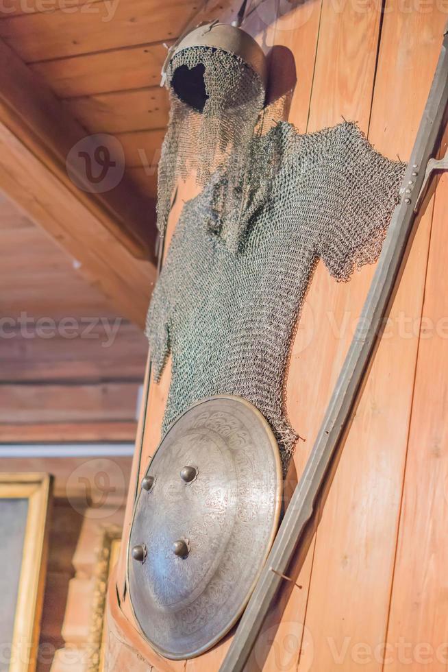 closeup of Medieval armors hanging on wooden wall photo