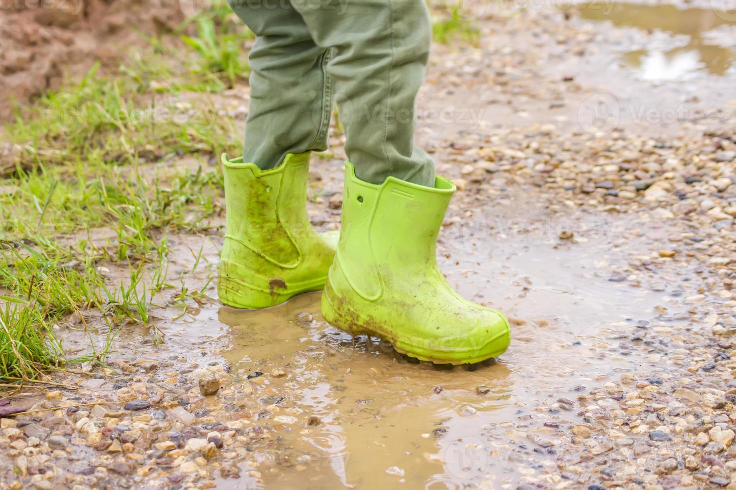 toddler boy in a mud puddle photo