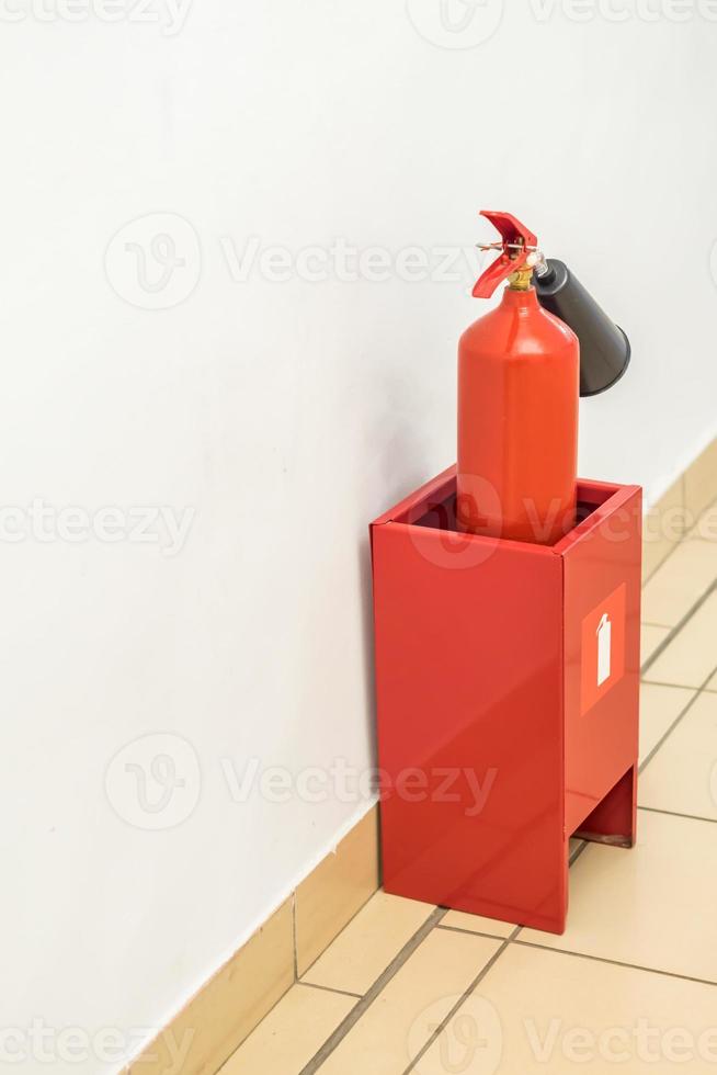 fire extinguisher near the wall indoors photo