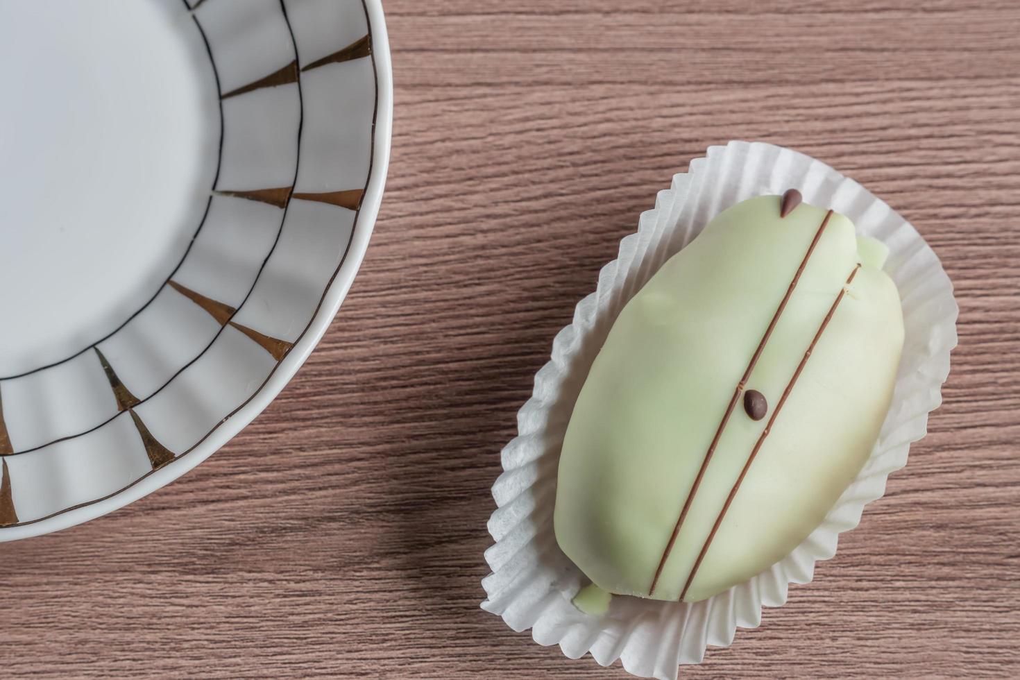 french eclair on wooden table photo