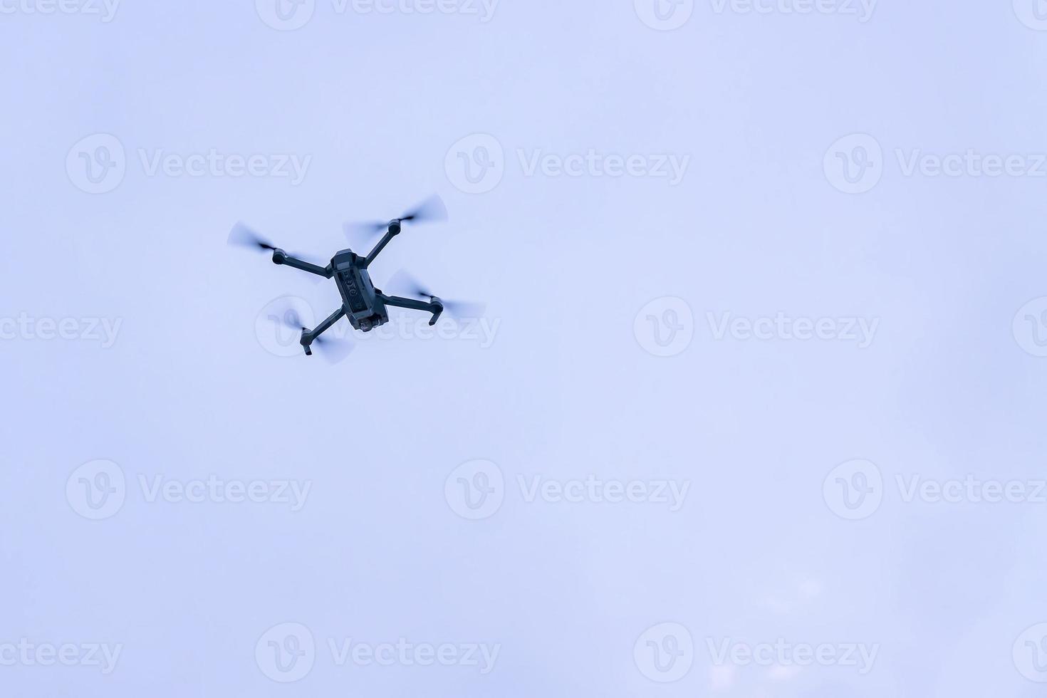 flying drone against blue sky photo