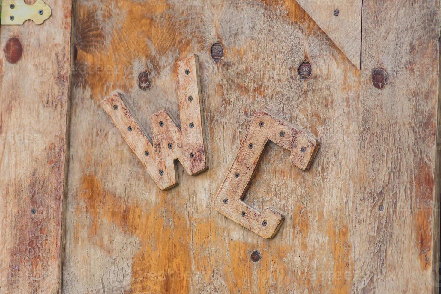 Toilet WC sign on old wooden door. photo