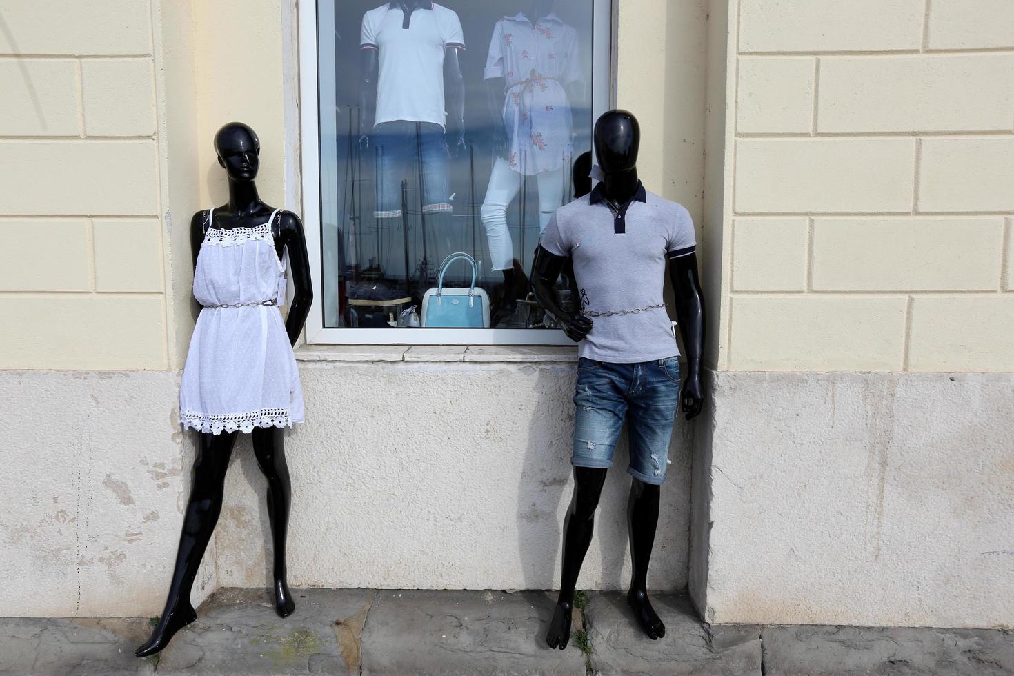 A mannequin stands on a showcase in a store. photo