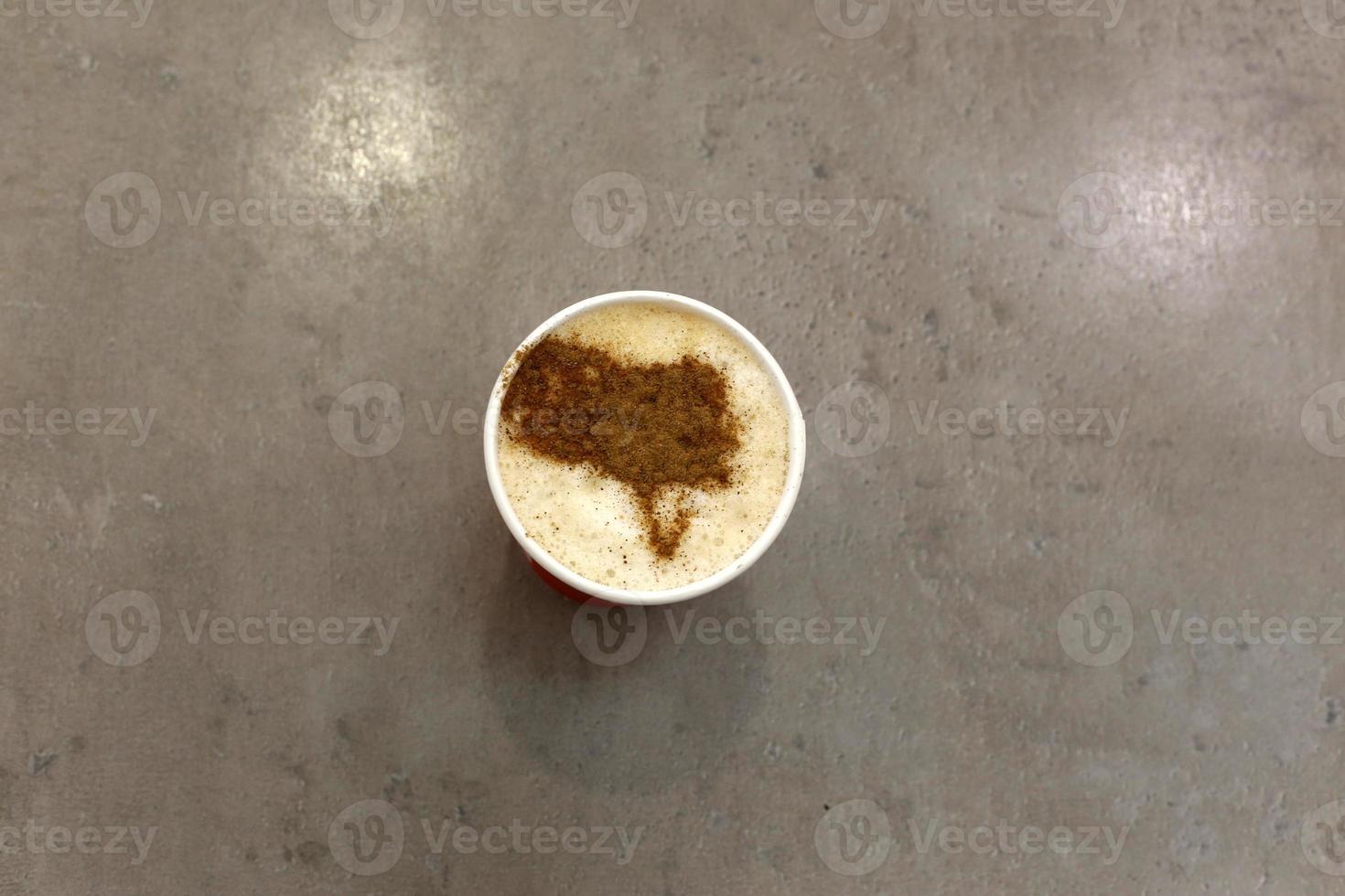Hot and strong coffee is poured into a cup. photo