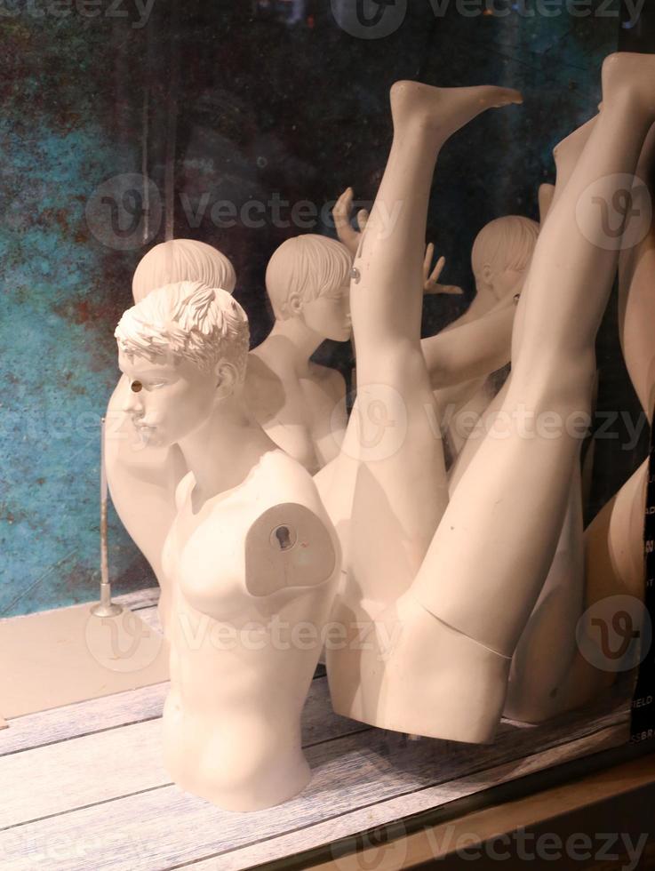 A mannequin stands on a showcase in a large store. photo