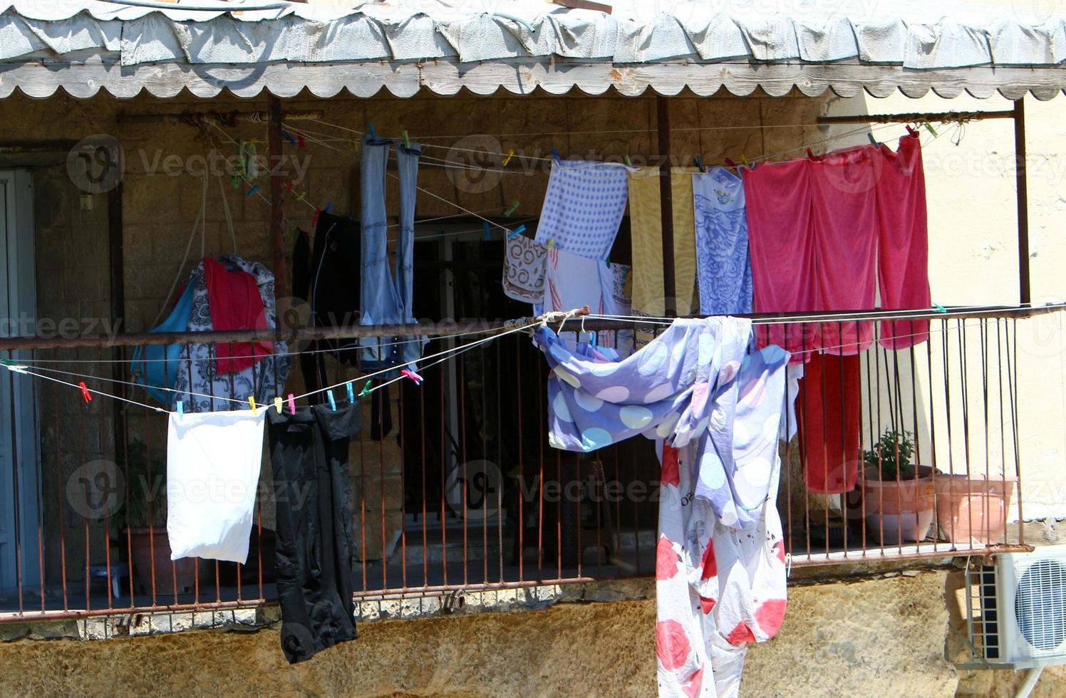 Outside the window, laundry is being dried on a rope on the facade of the building. photo