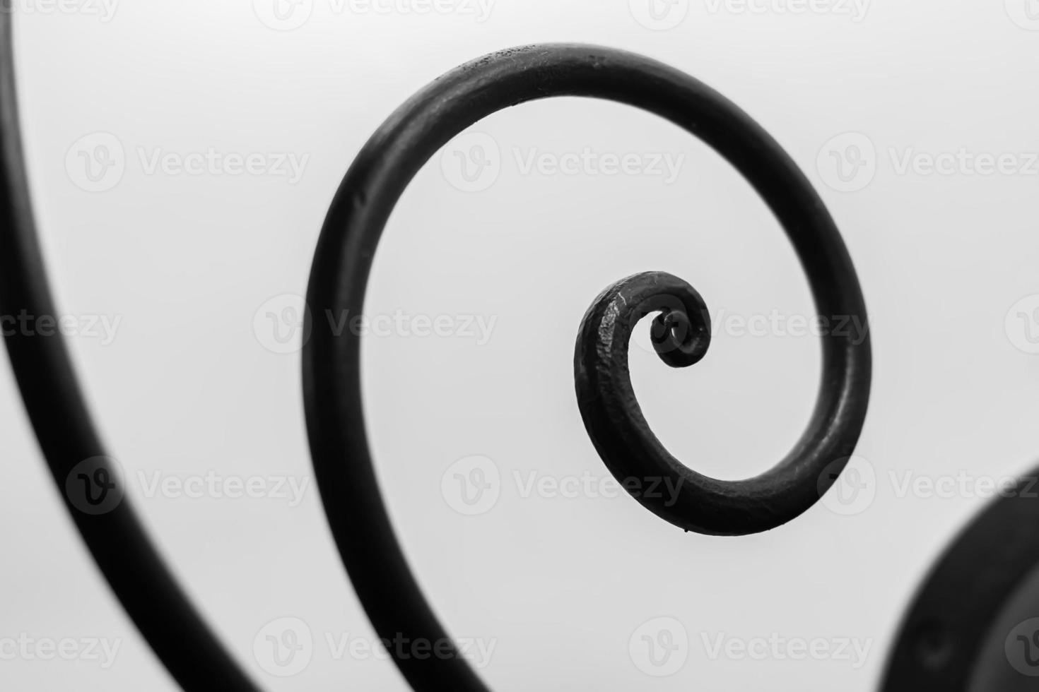 Close up view of iron decorative curved elements on white background photo