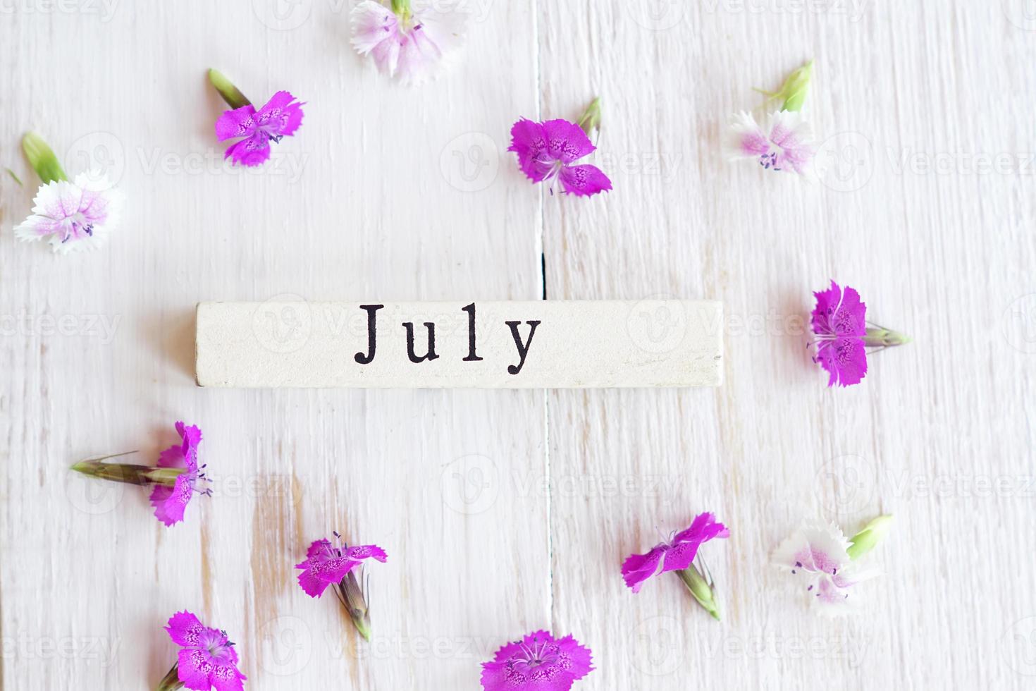 first day of July, colorful background with calendar and pink flowers photo