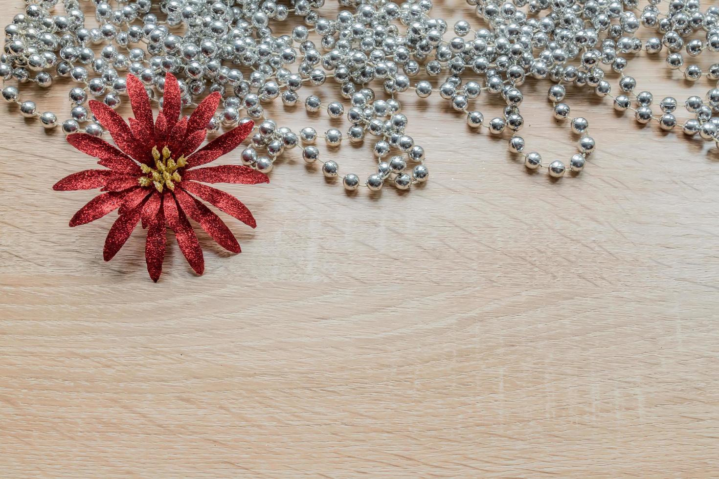 Christmas New Year holiday background. Silver garland and red flower photo