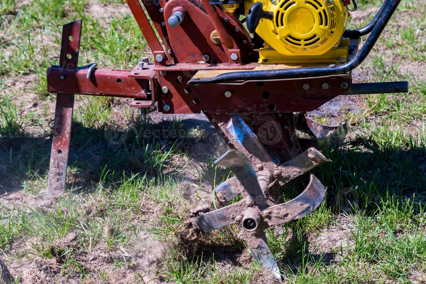 close up of small hand tractor motoblock for plowing field. photo
