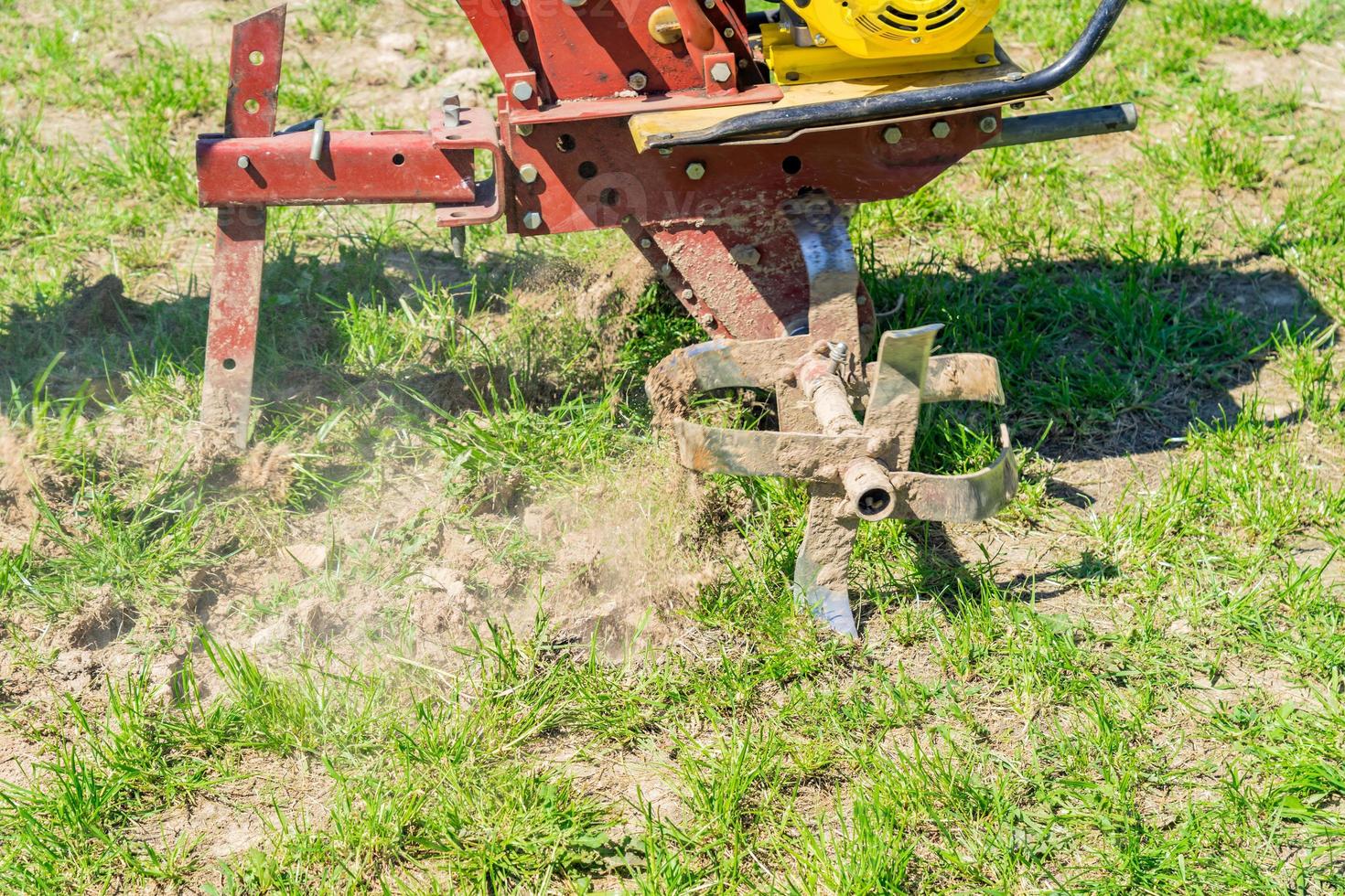 close up of small hand tractor motoblock for plowing field. photo