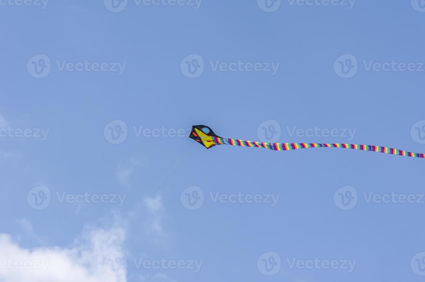 Kite flying in the sky among the clouds photo