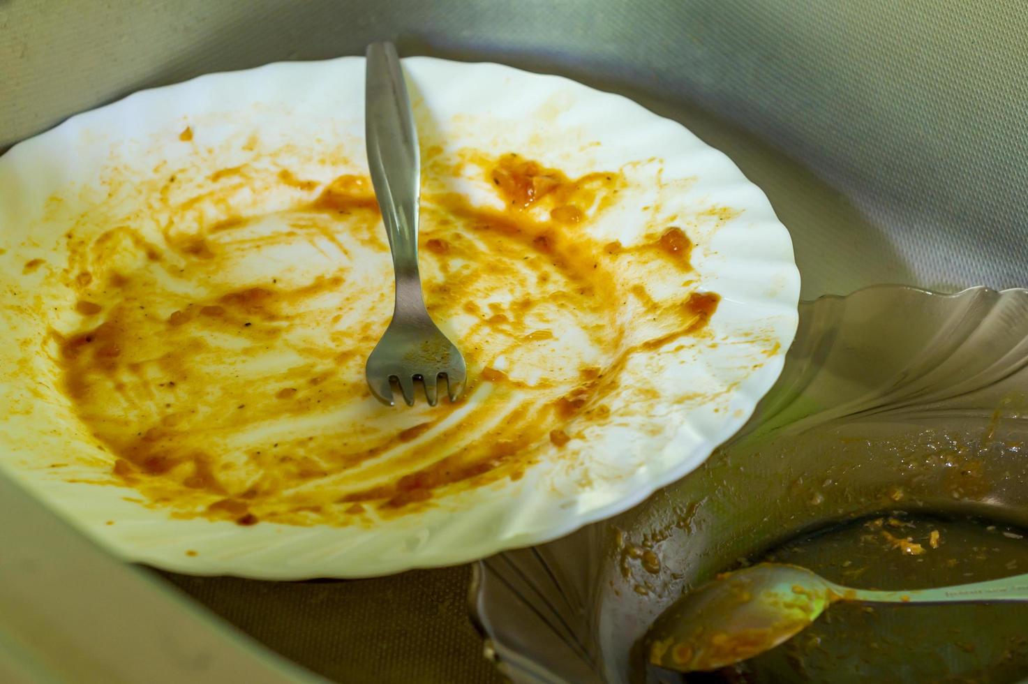 dirty dishes in metal sink photo