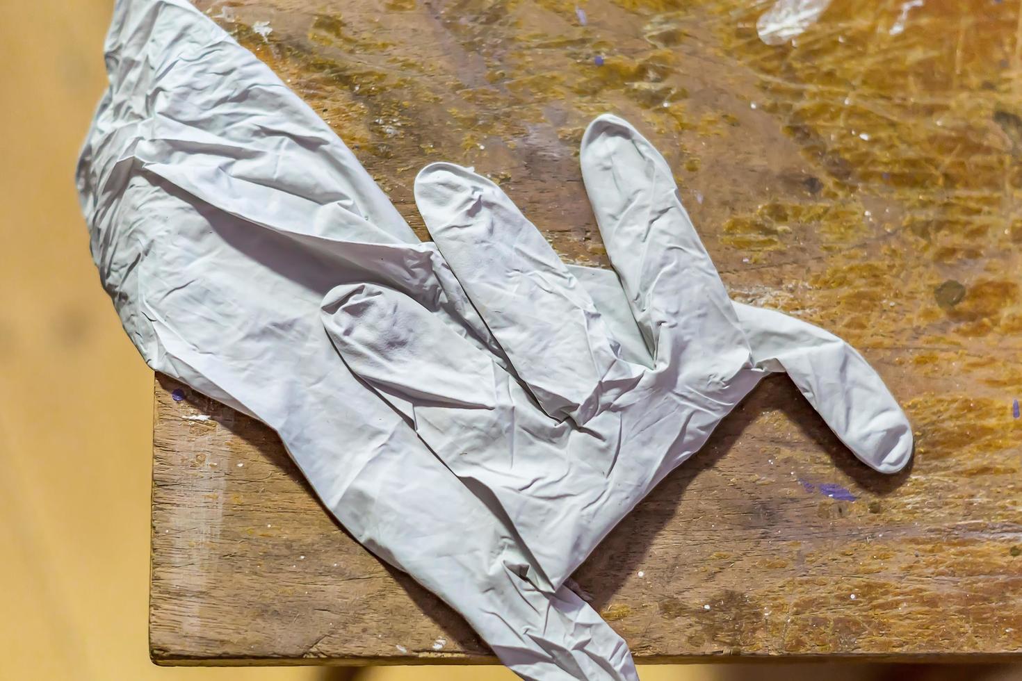 latex glove on wooden table photo