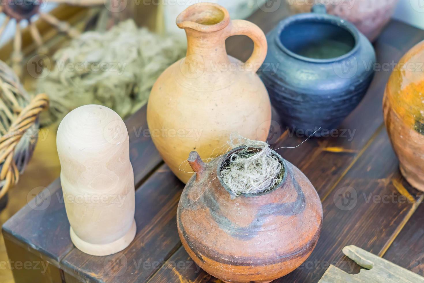 variety of clay pottery standing on wooden table photo