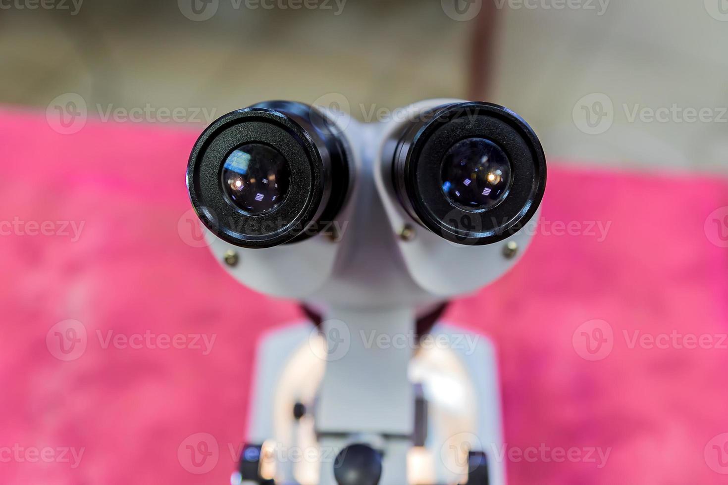 Laboratory Equipment, Optical Microscope for school lessons on red table photo