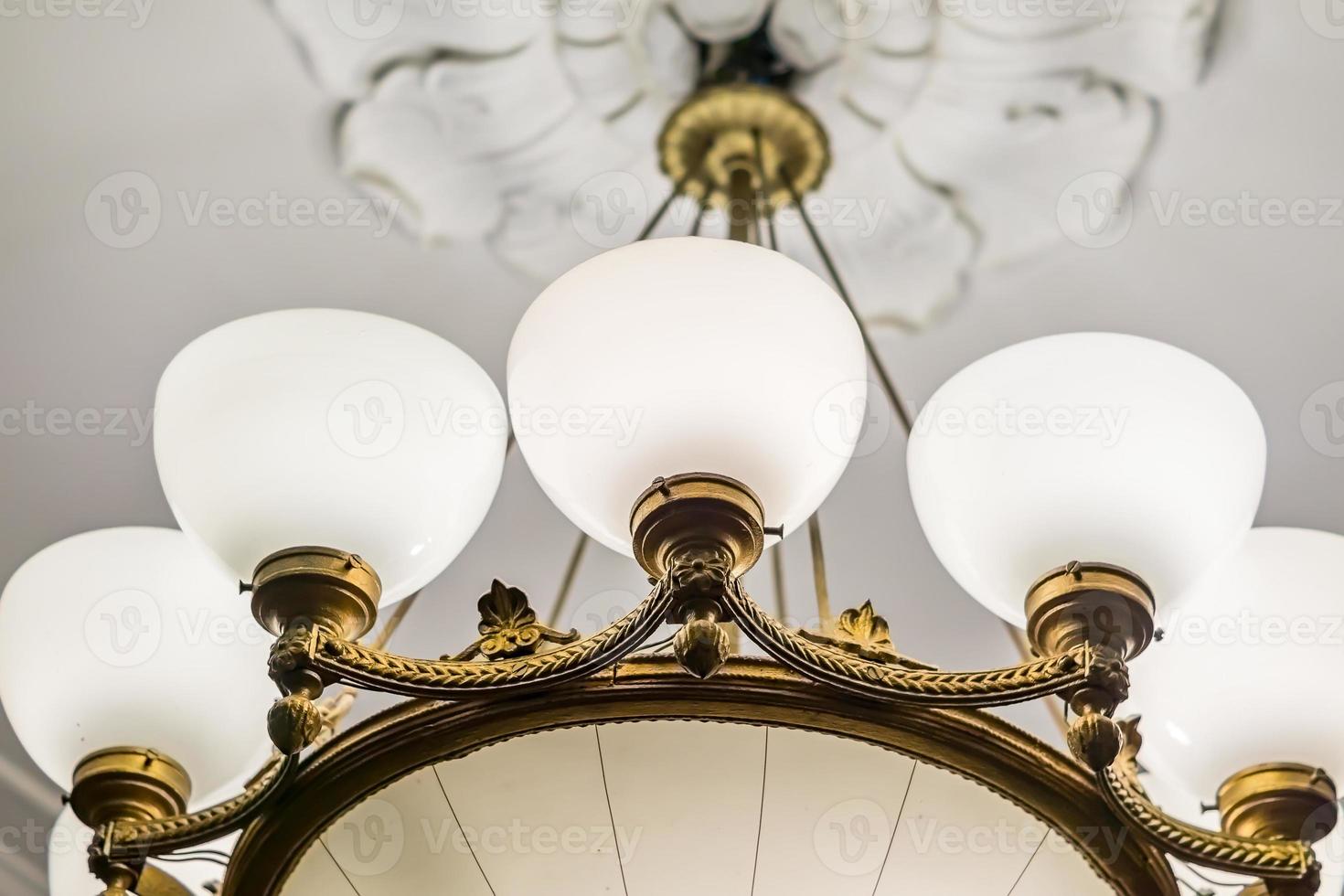 retro styled chandelier on ceiling, closeup. photo