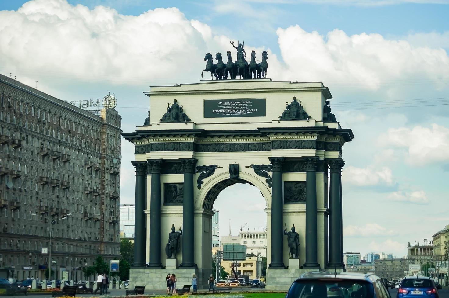 Moscow, Russia, July 13, 2017 Triumphal Arch of Moscow against summer cloudy sky and traffic on Kutuzovsky boulevard. photo