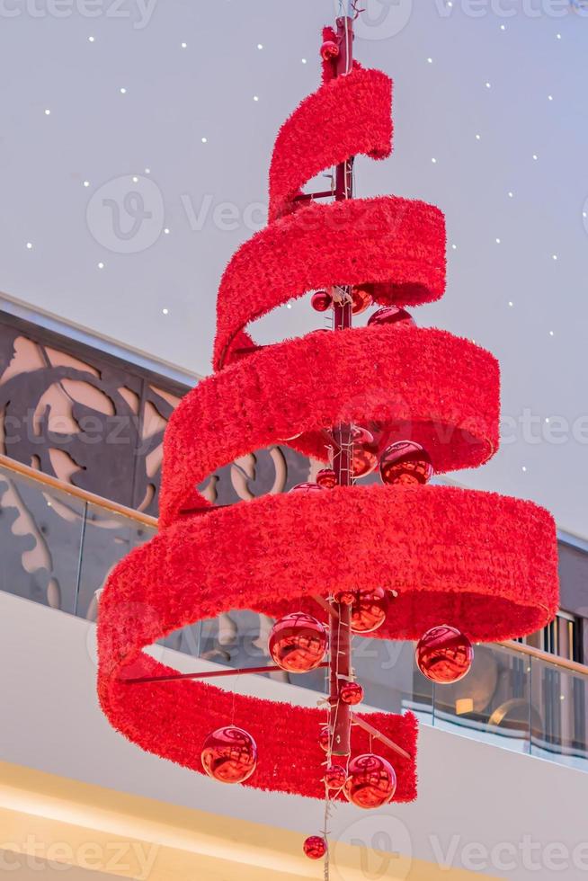 red xmas tree and garland hanging on ceiling closeup photo