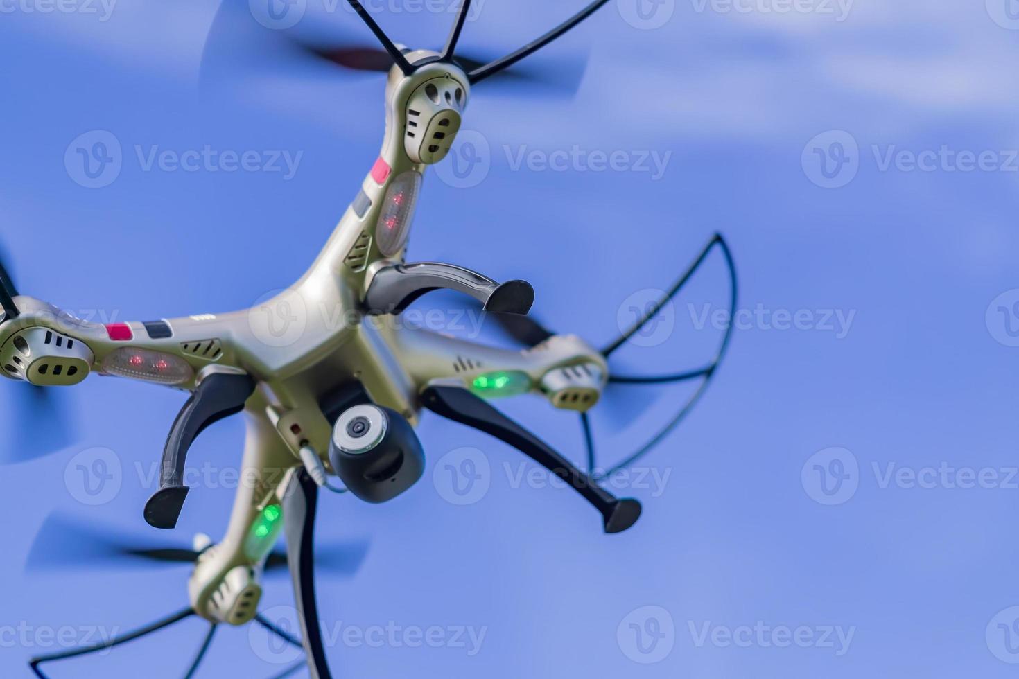 flying drone with remote control against blue sky background. photo