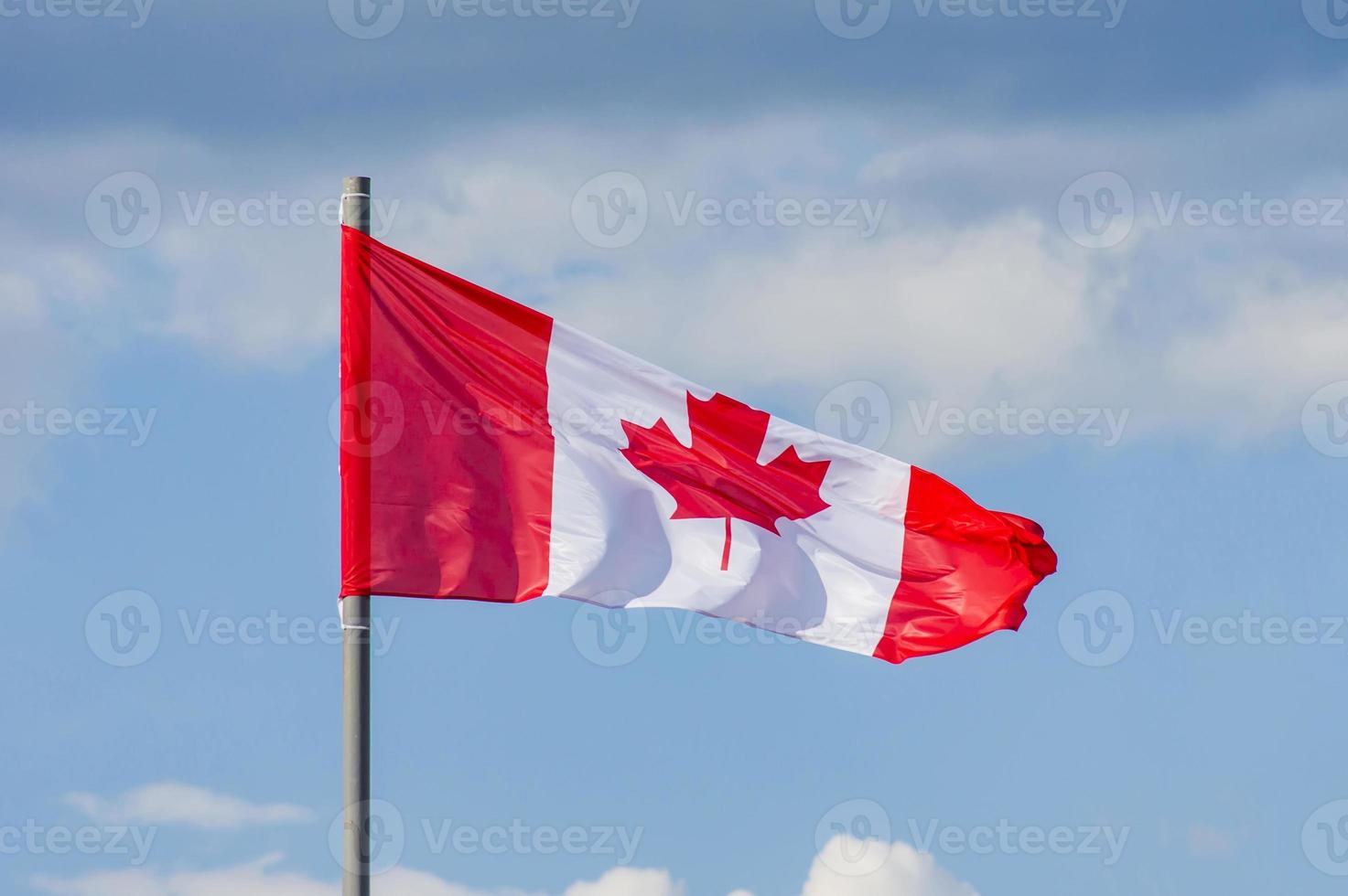 The National flag of Canada flay over the blue sky photo