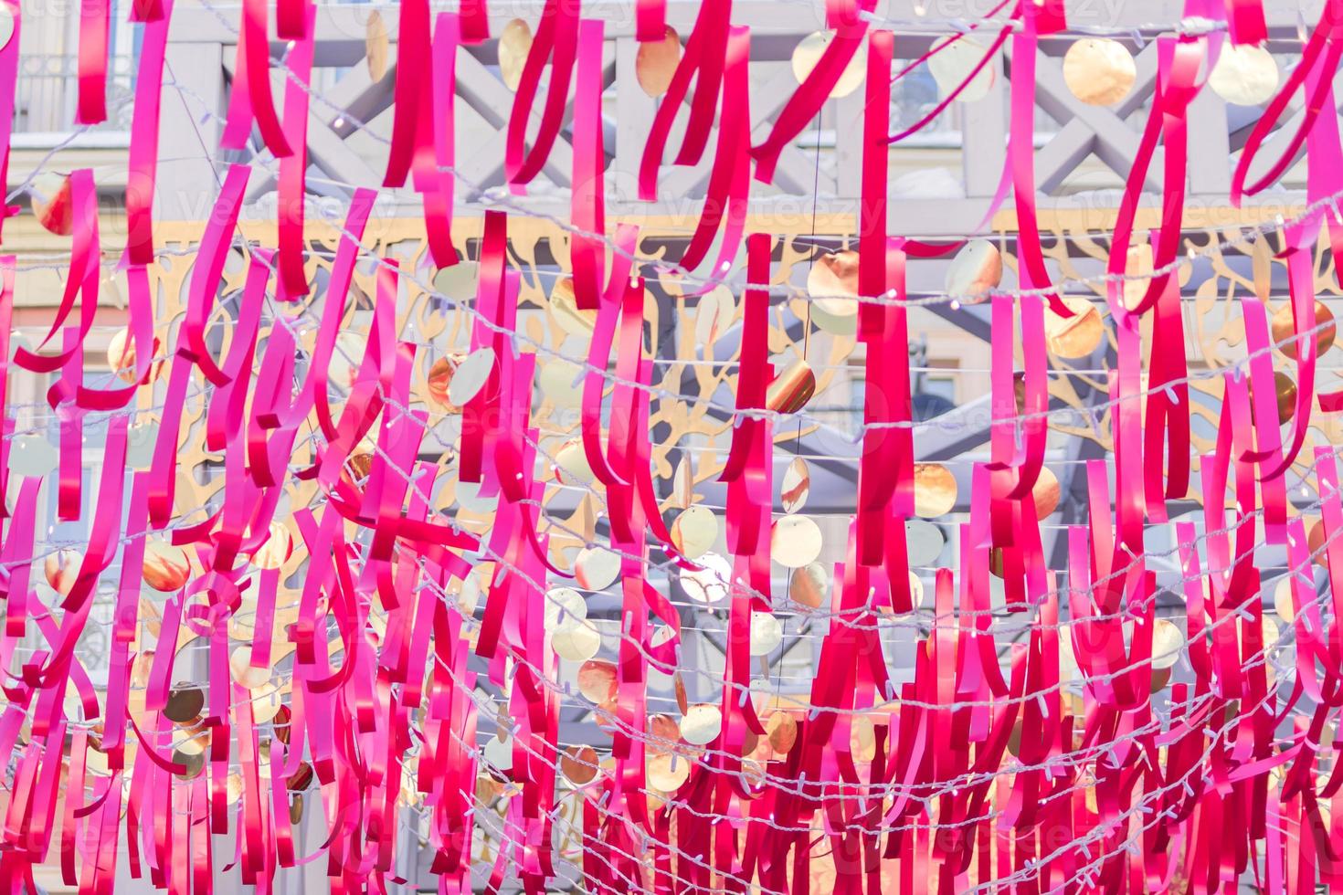 red strips of cloth hanging on a string against blue sky photo