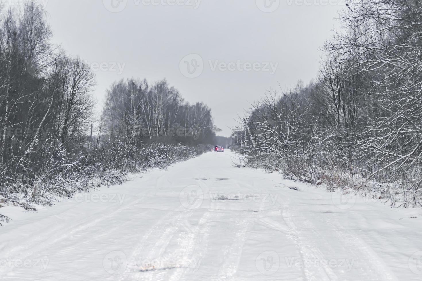 acar with stop lights on winter road photo