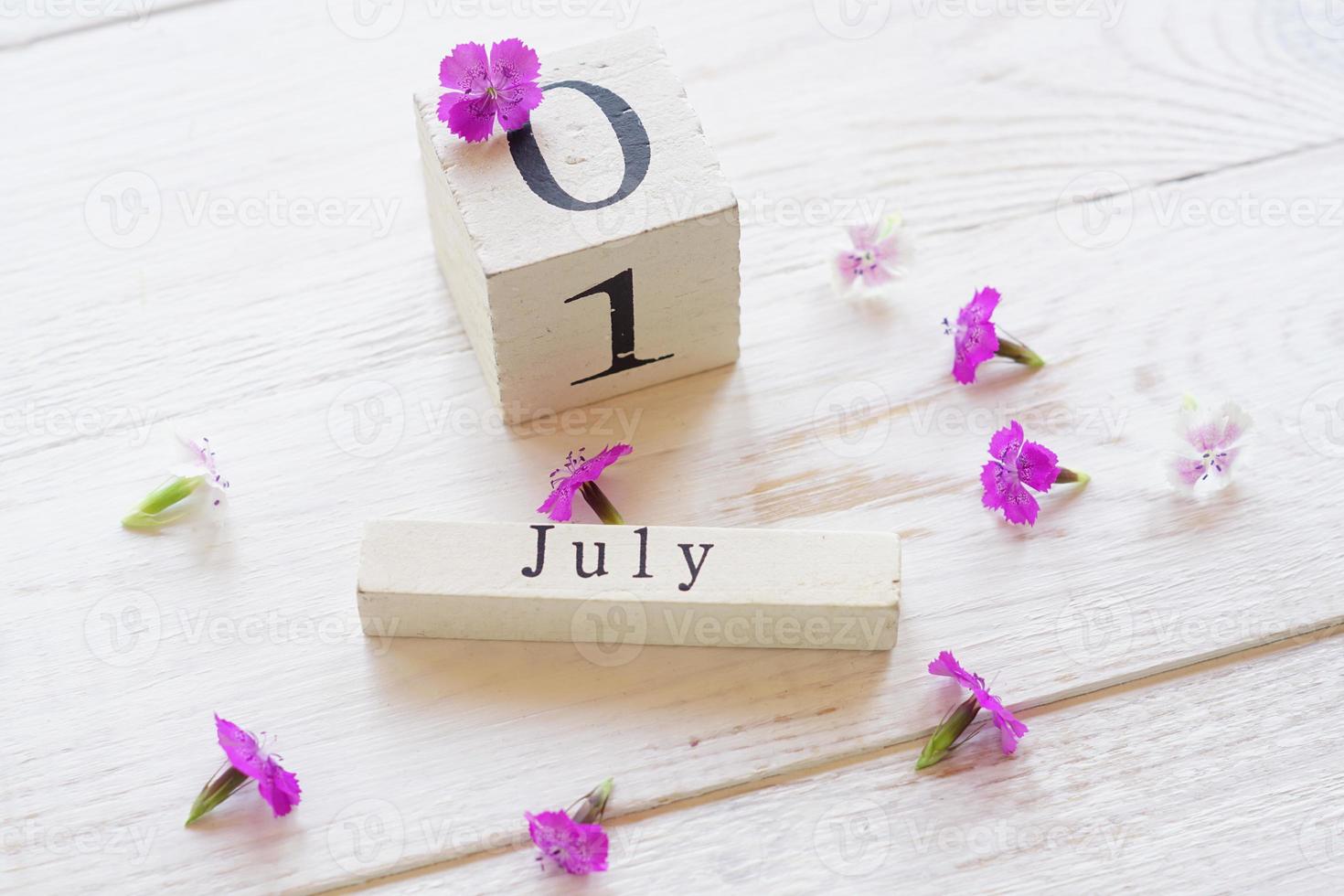 first day of July, colorful background with calendar, flowers photo