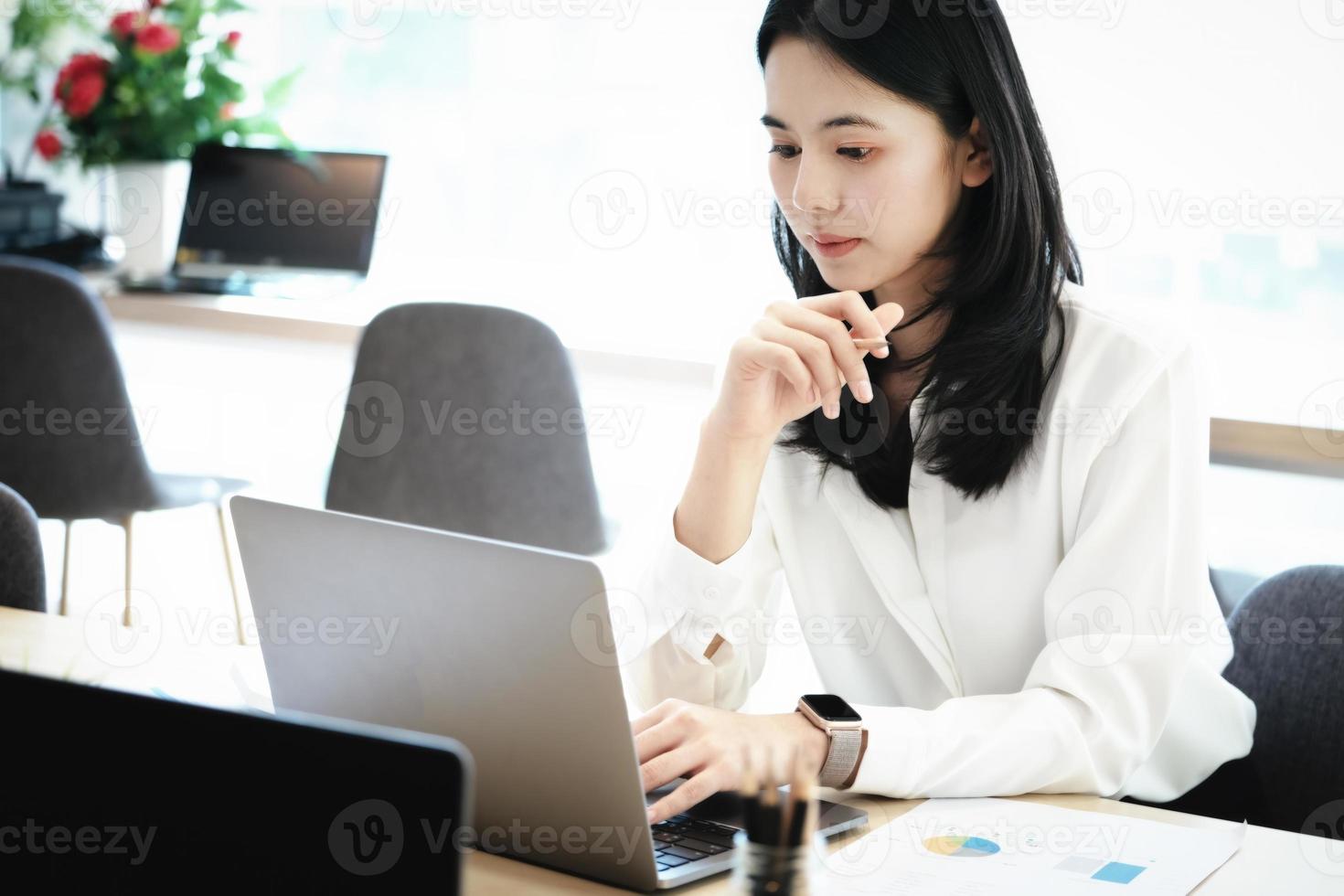 Female employees are working at home through computers to maintain social distancing to reduce the spread of coronavirus. photo