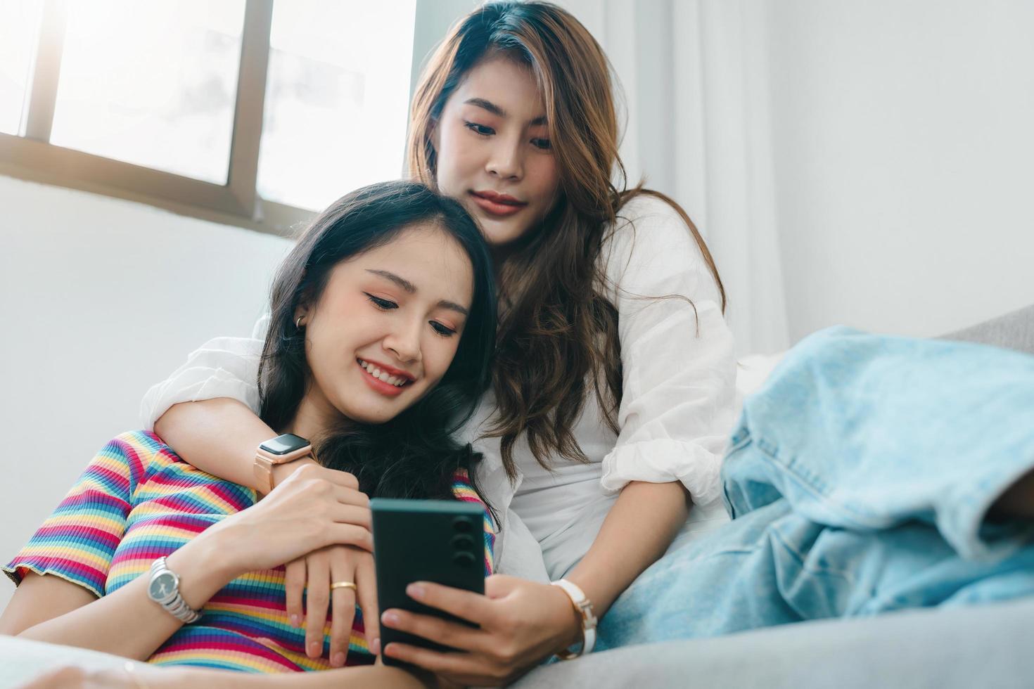 lgbtq, lgbt concept, homosexuality, portrait of two asian women enjoying together and showing love for each other while using smartphone mobile to take selfies photo