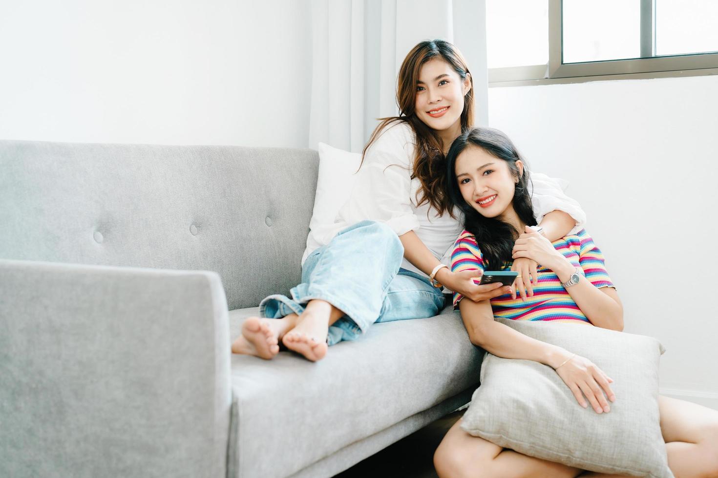 lgbtq, lgbt concept, homosexuality, portrait of two asian women enjoying together and showing love for each other while using smartphone mobile to take selfies photo
