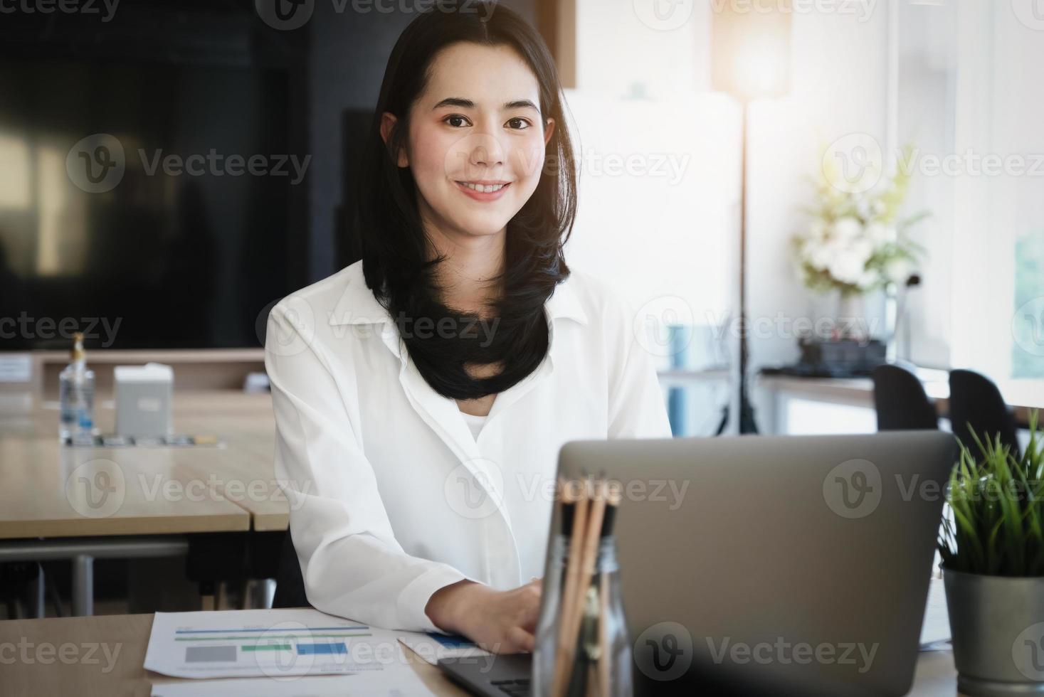 Female employees are working at home through computers to maintain social distancing to reduce the spread of coronavirus. photo