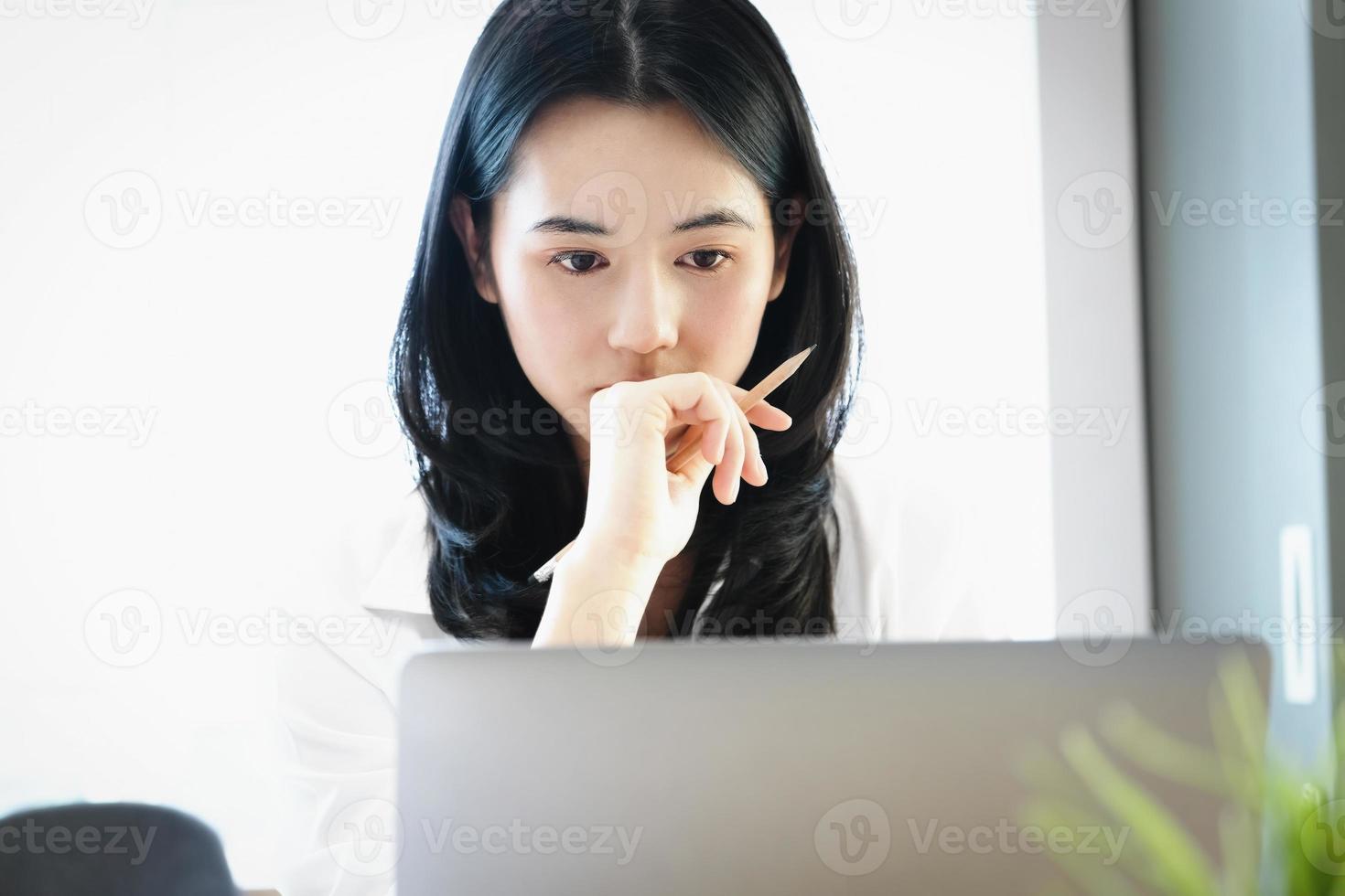Female employees are working at home through computers to maintain social distancing to reduce the spread of coronavirus. photo