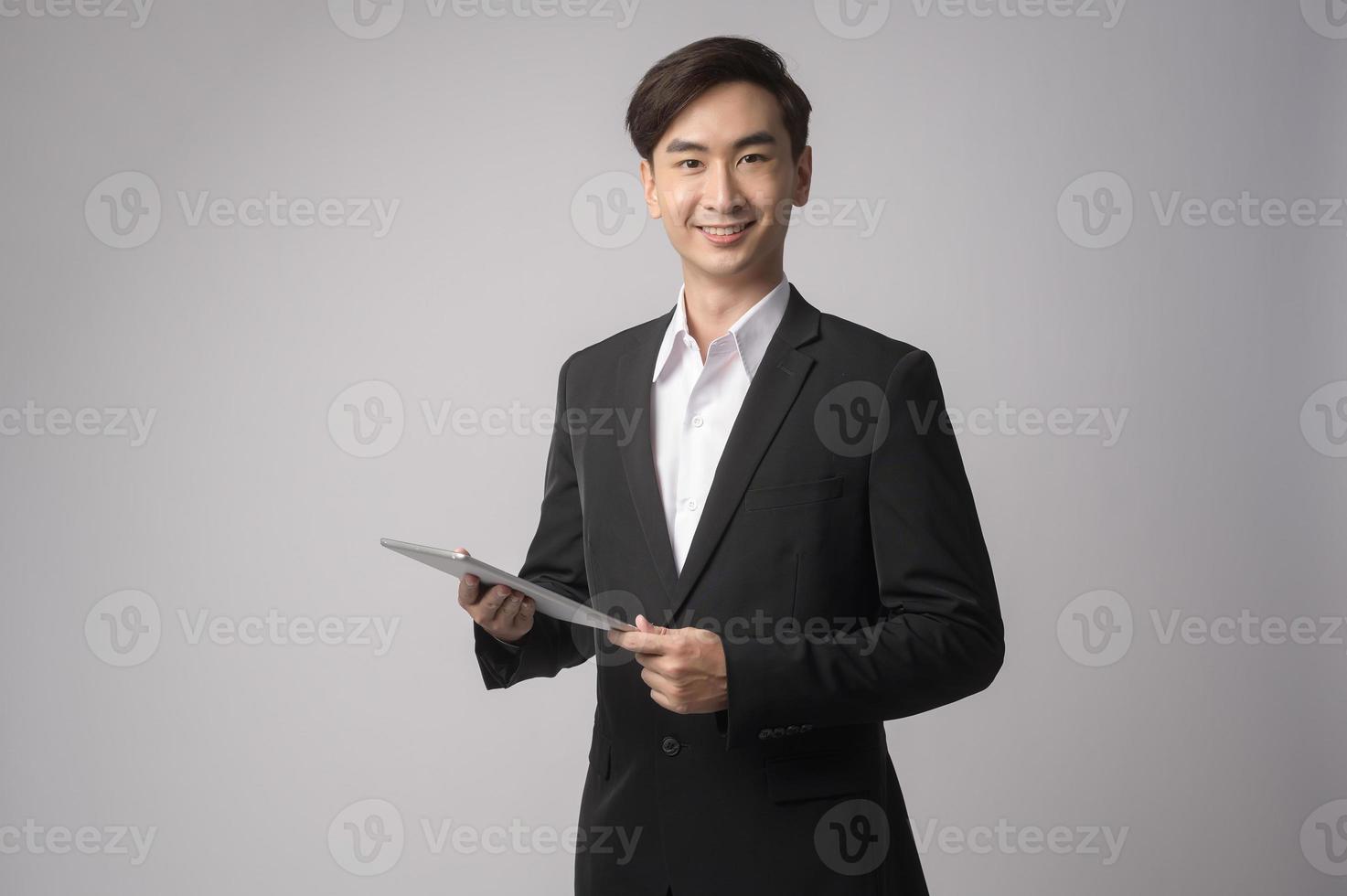 Young businessman wearing  suit over white background studio photo