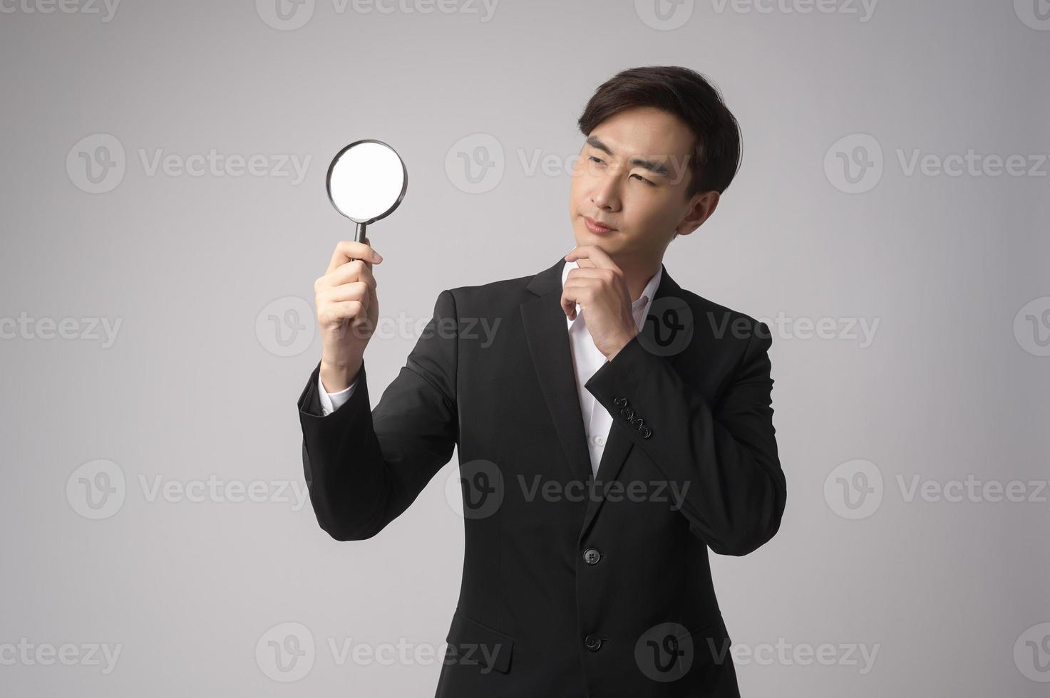 Young businessman wearing  suit over white background studio photo