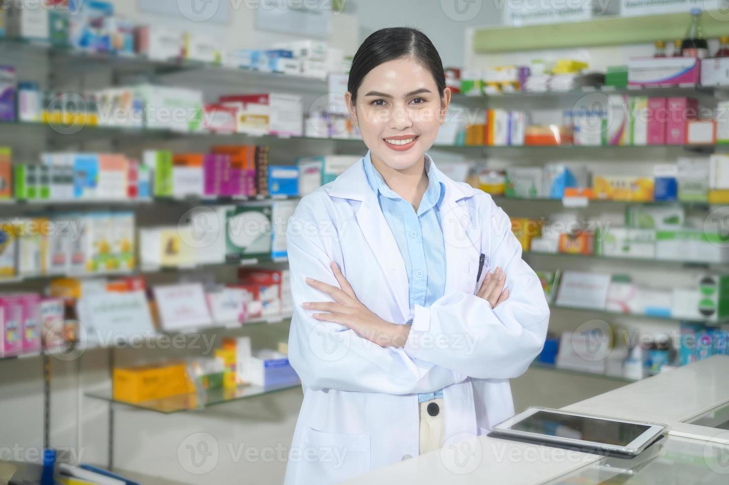 Portrait of female pharmacist working in a modern pharmacy drugstore. photo