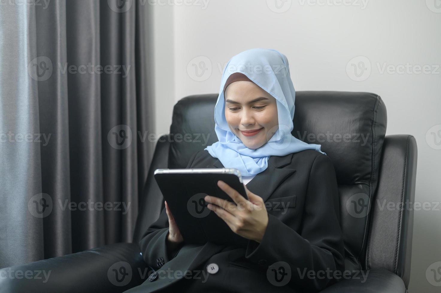 Young muslim business woman using tablet in modern office photo