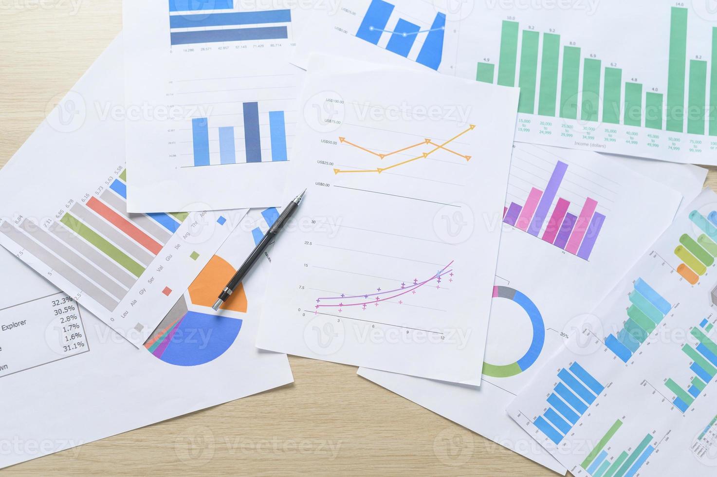 Top view of Documents with analytics data lying on table,selective focus photo