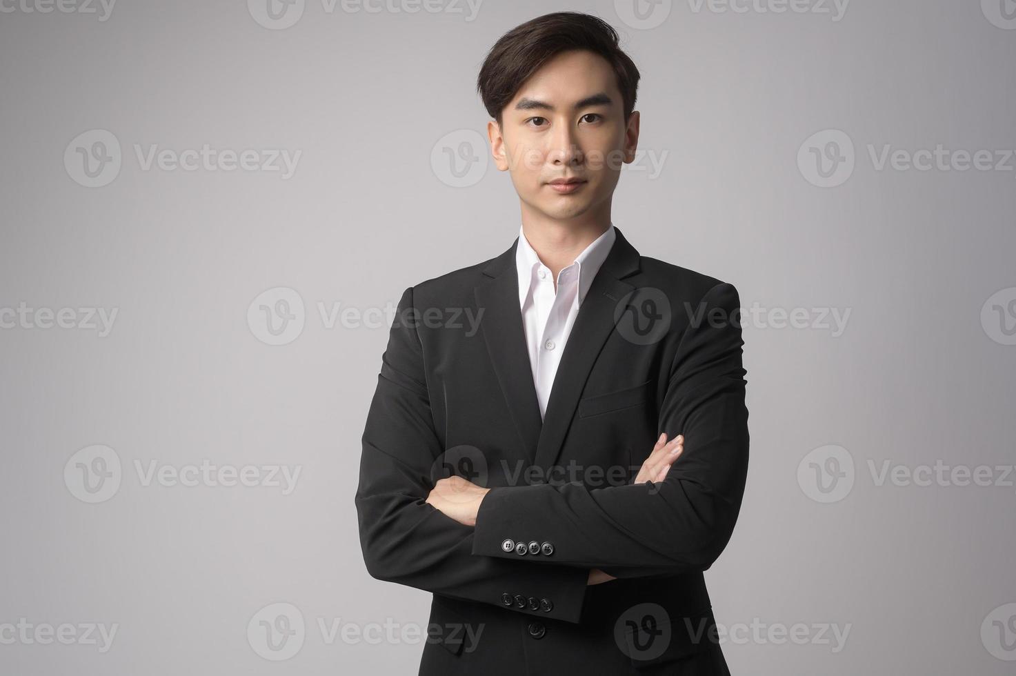 Young businessman wearing  suit over white background studio photo