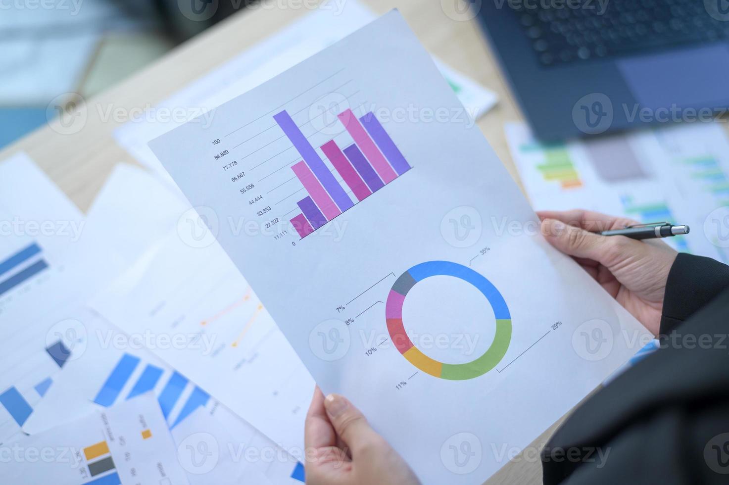 Top view of Documents with analytics data lying on table,selective focus photo
