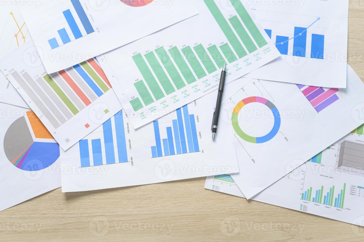 Top view of Documents with analytics data lying on table,selective focus photo