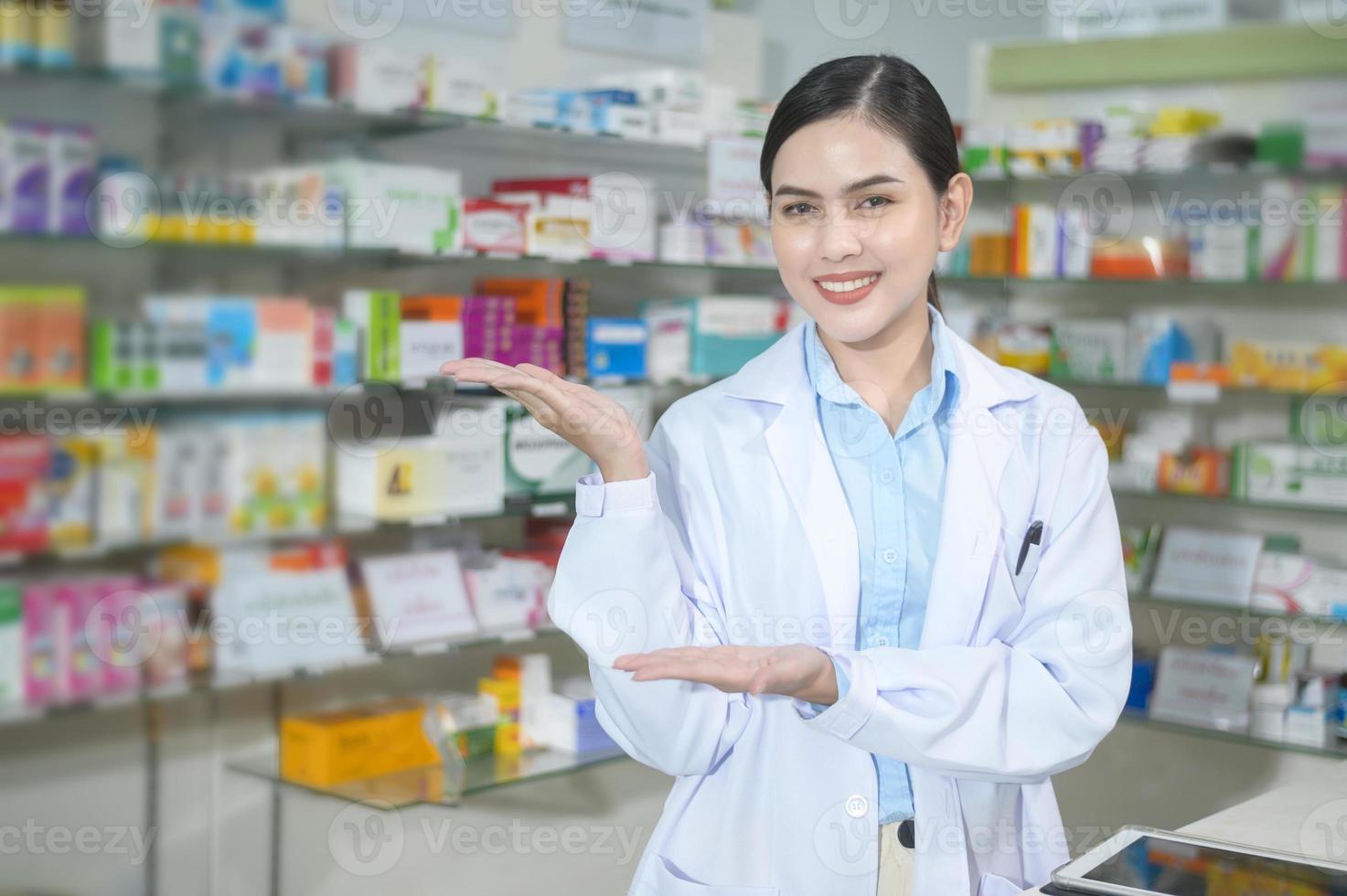 Portrait of female pharmacist working in a modern pharmacy drugstore. photo